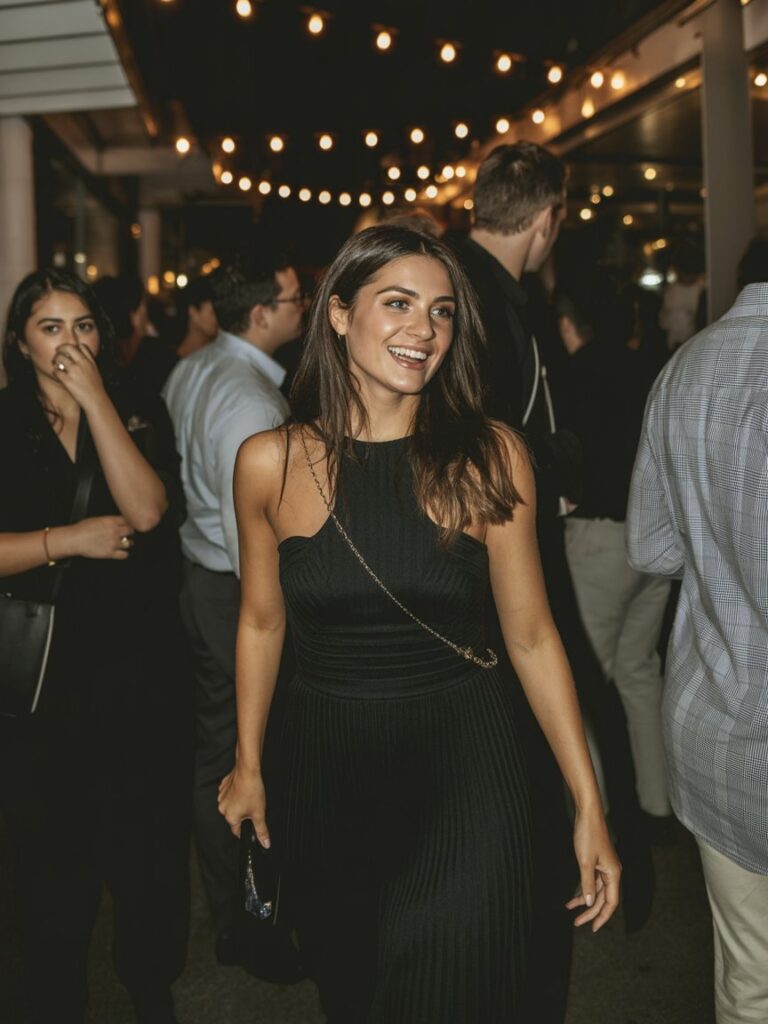 Confident woman turning heads in a black evening dress at night