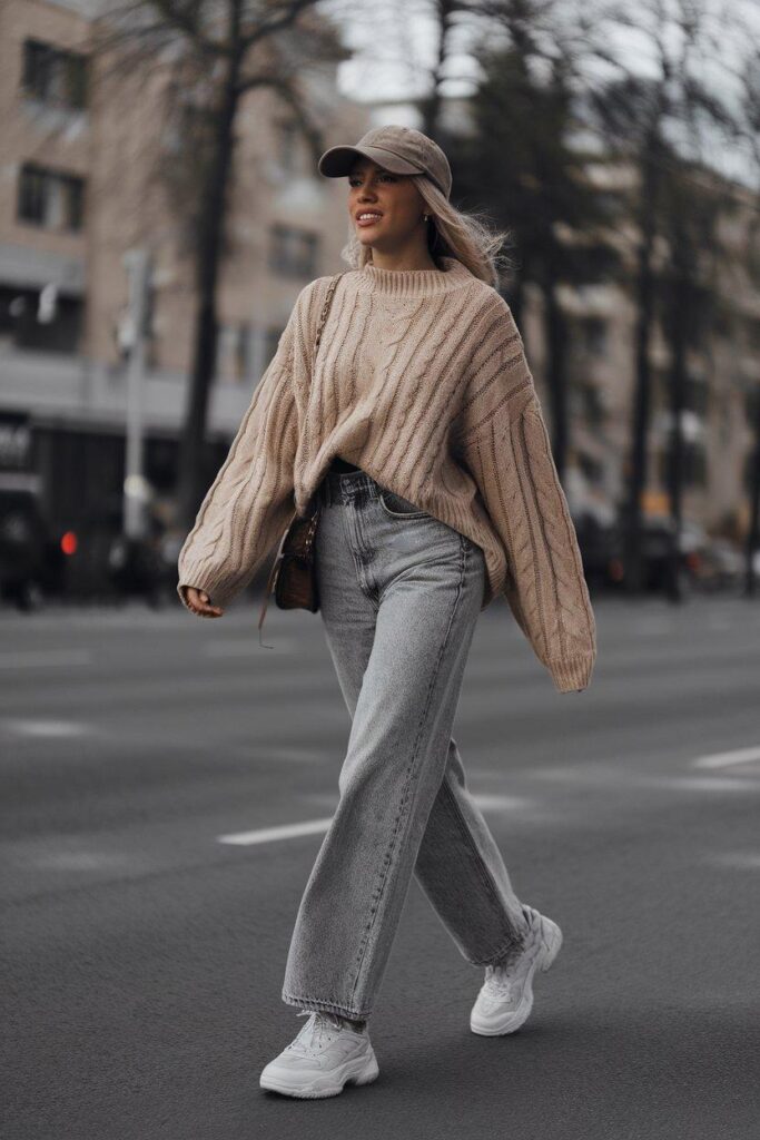 Casual winter outfit with oversized sweater, jeans, and sneakers