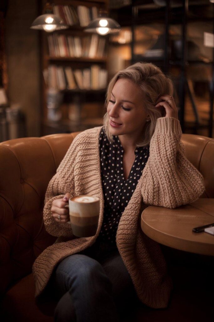 Polka dot blouse layered with chunky cardigan for cozy casual outfit
