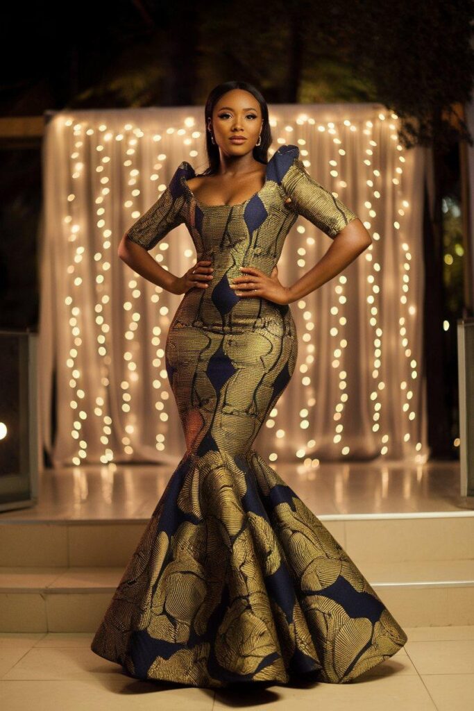 African woman posing in elegant Ankara mermaid dress at evening event